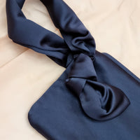 AUGUST NIGHT KNOT CLUTCH IN NAVY SATIN