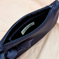 AUGUST NIGHT KNOT CLUTCH IN NAVY SATIN