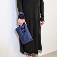 AUGUST NIGHT KNOT CLUTCH IN NAVY SATIN