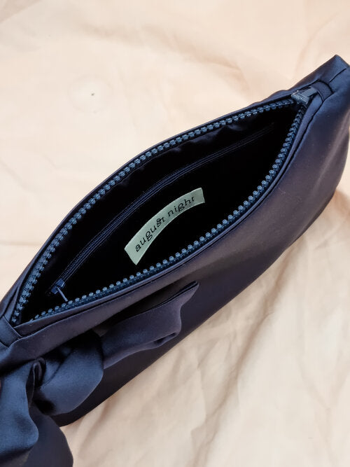 AUGUST NIGHT KNOT CLUTCH IN NAVY SATIN